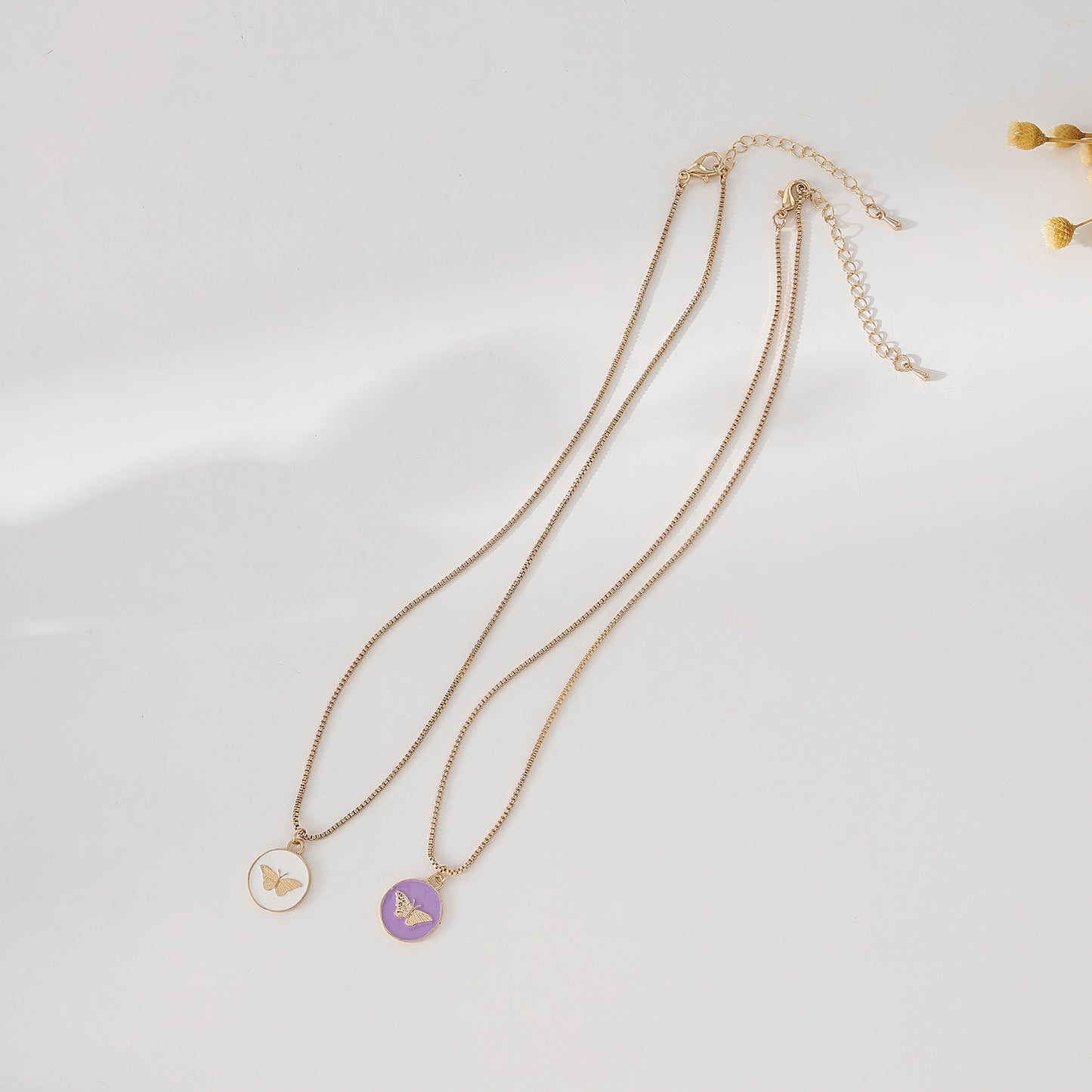 Enchanting Gold - Tone Chain Necklace with Round Enamel Pendants Featuring Delicate Butterfly Designs