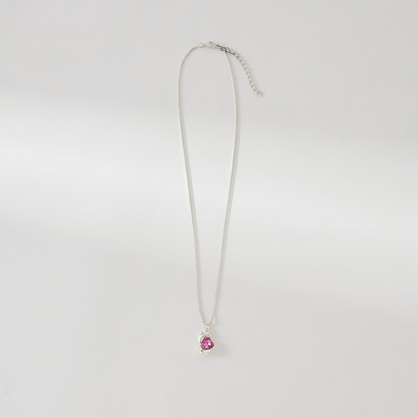 Two Dolphins surrounding Crystal Heart pendant on silvery chain Necklace