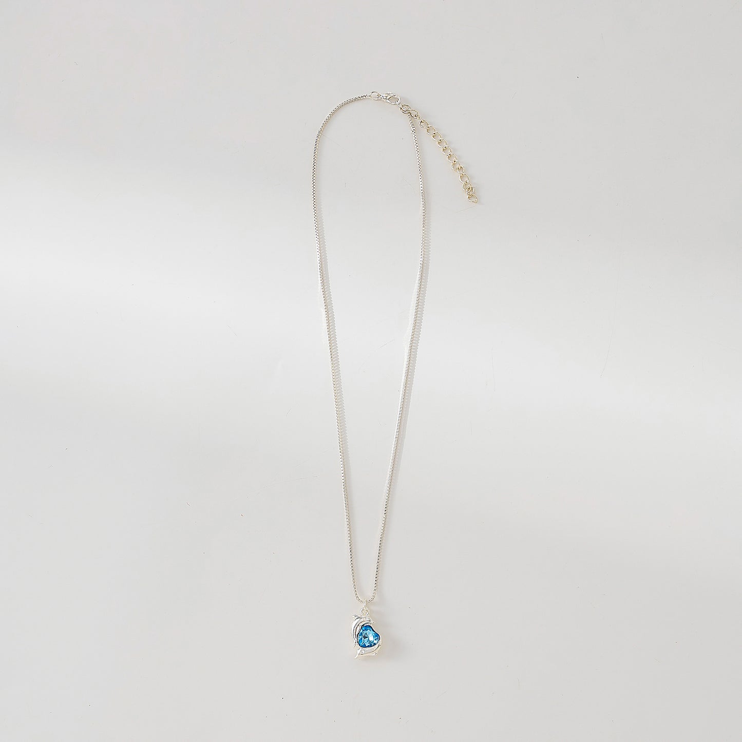Two Dolphins surrounding Crystal Heart pendant on silvery chain Necklace