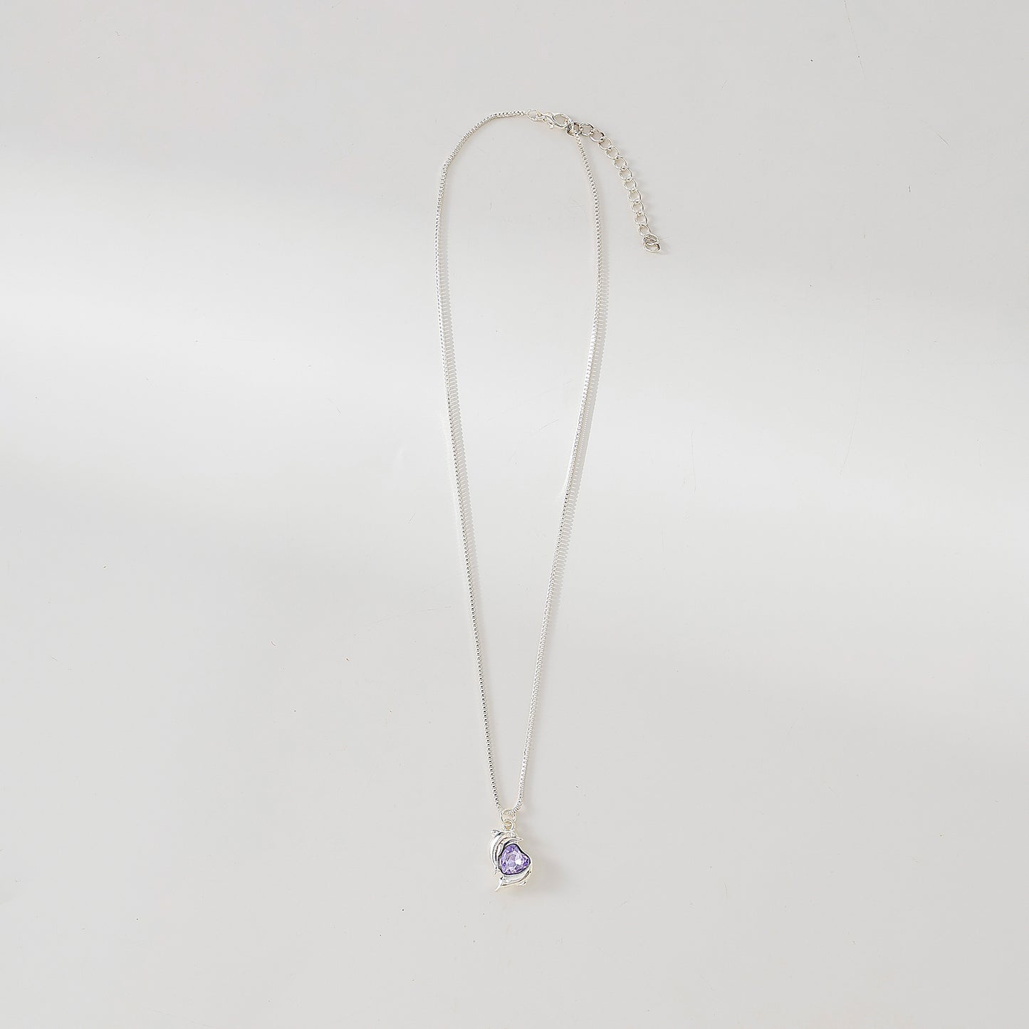 Two Dolphins surrounding Crystal Heart pendant on silvery chain Necklace