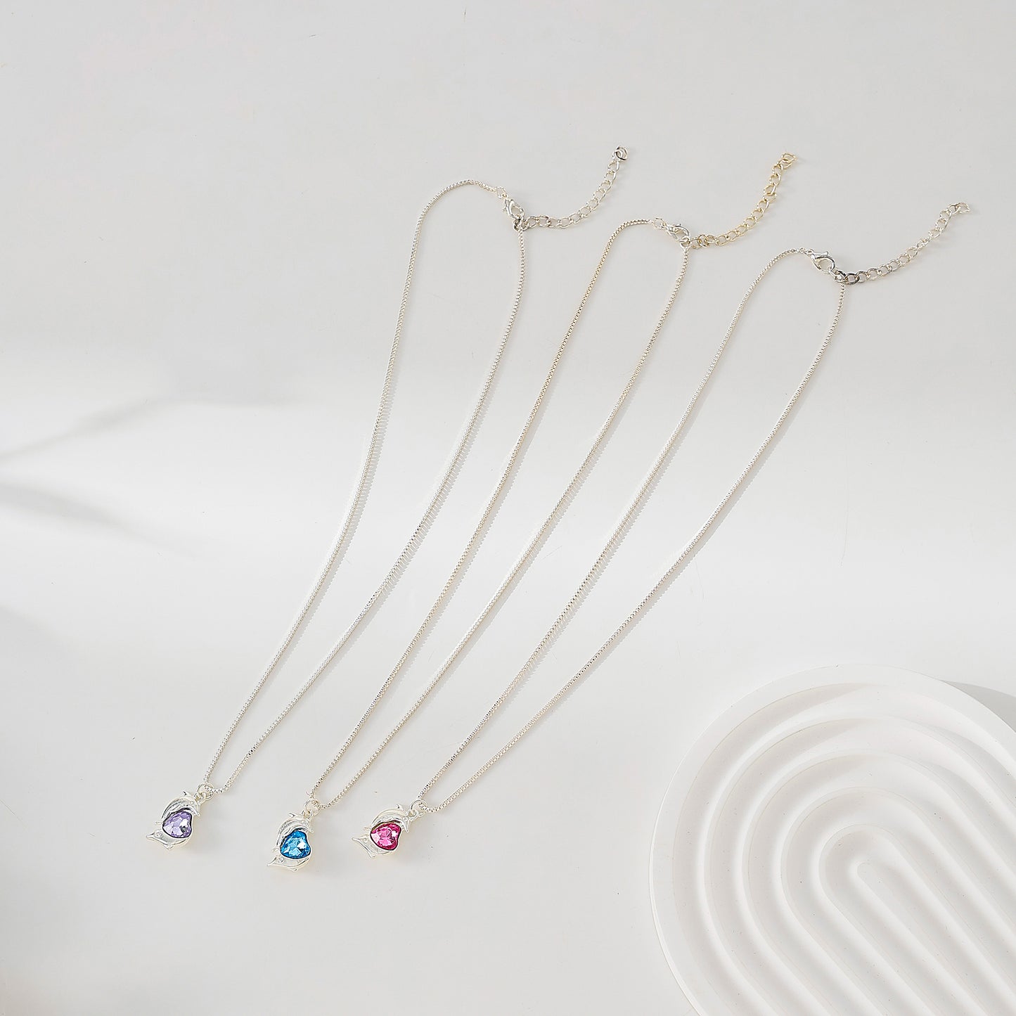 Two Dolphins surrounding Crystal Heart pendant on silvery chain Necklace