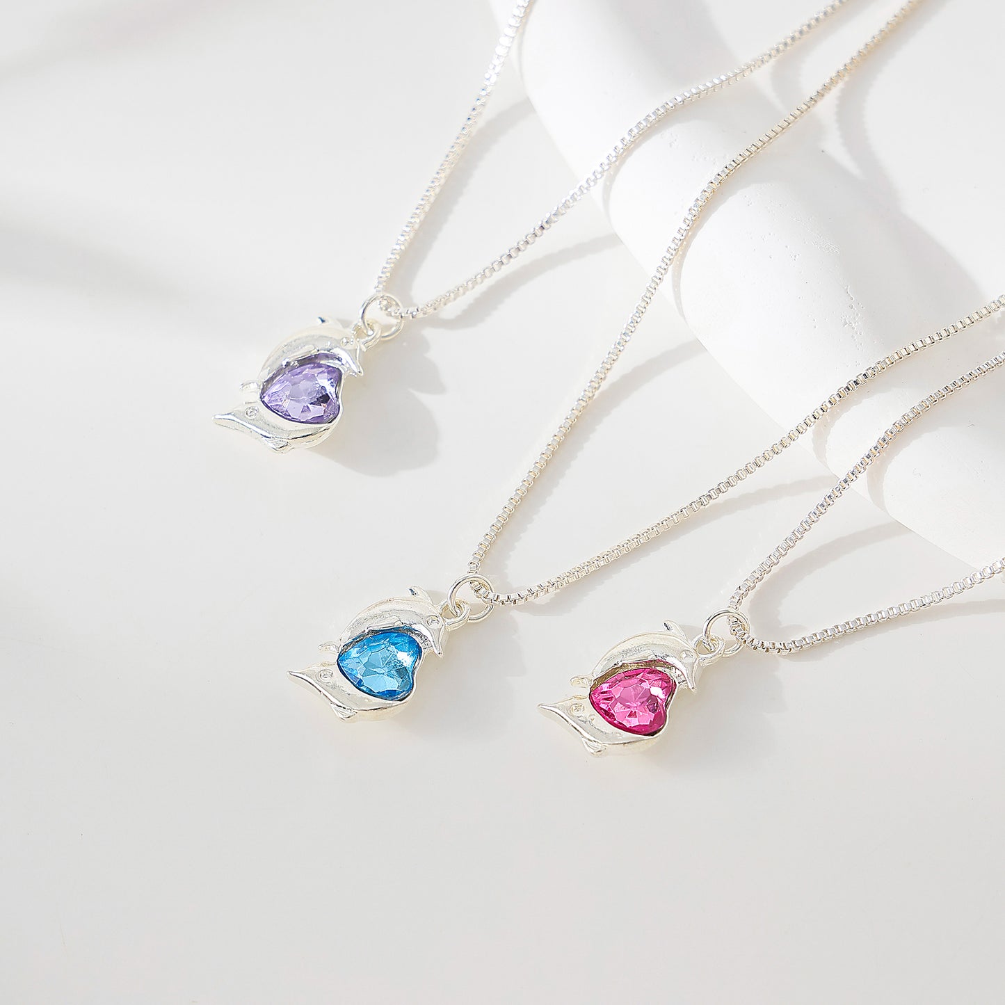 Two Dolphins surrounding Crystal Heart pendant on silvery chain Necklace
