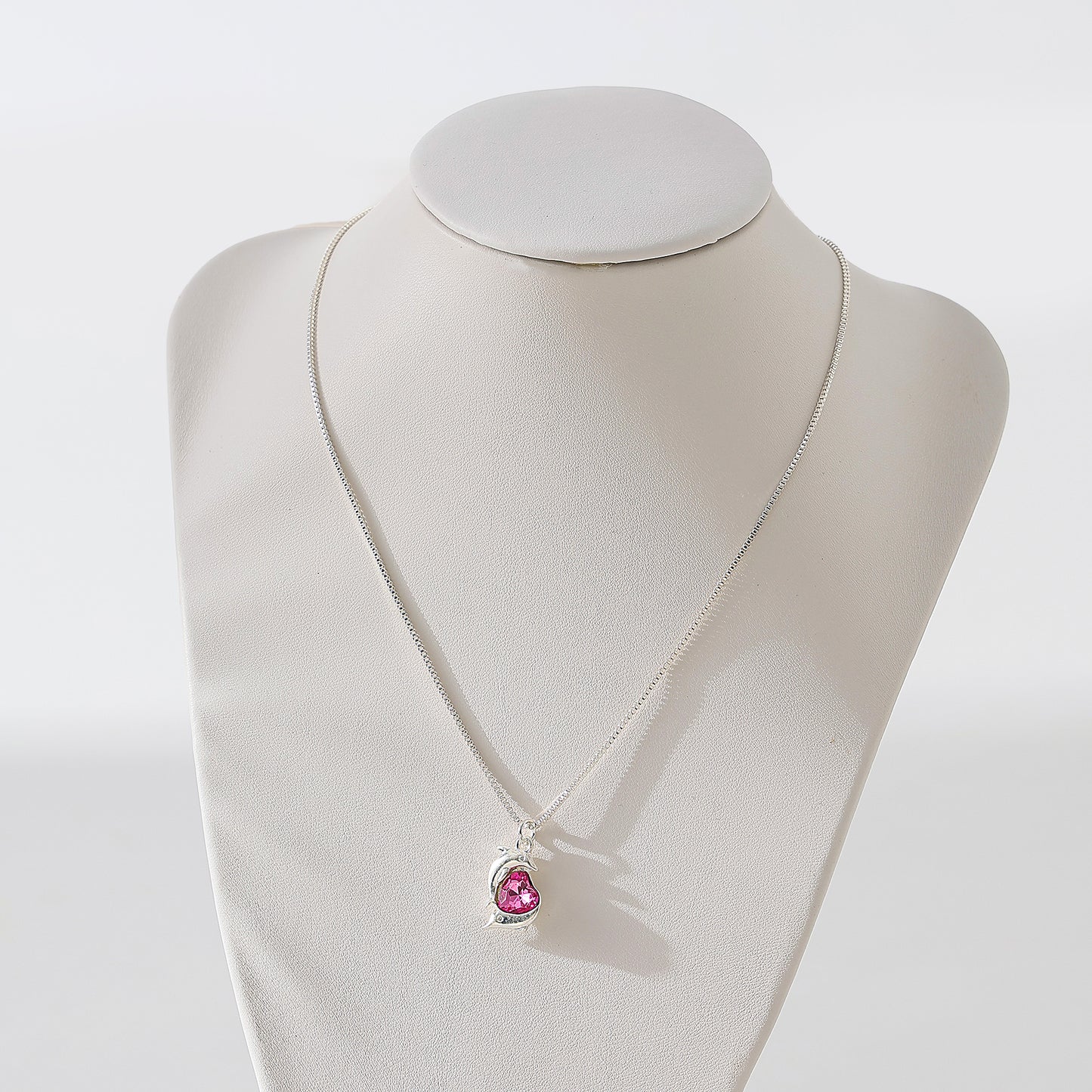 Two Dolphins surrounding Crystal Heart pendant on silvery chain Necklace