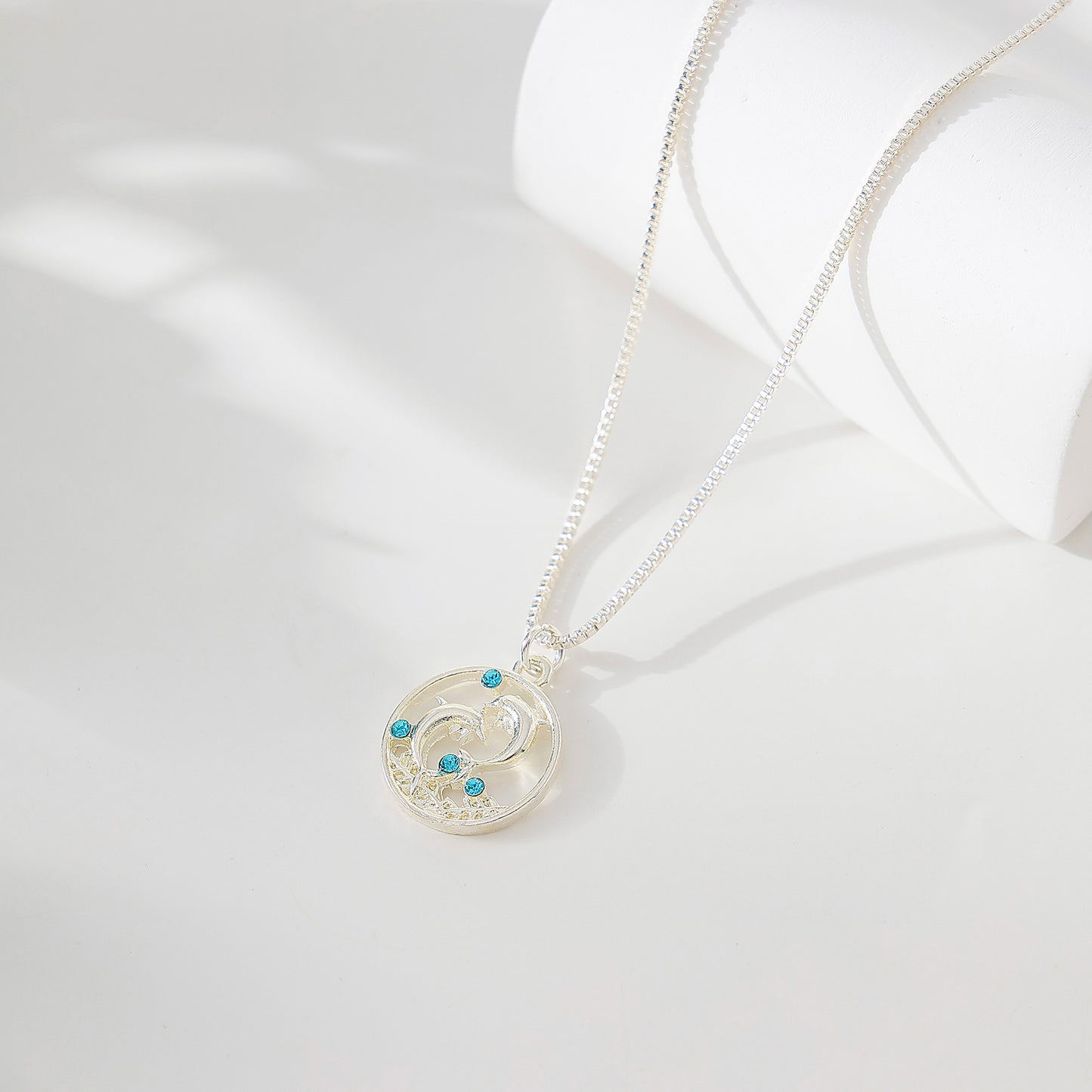 Dolphins on round pendant with blue crystals Necklace