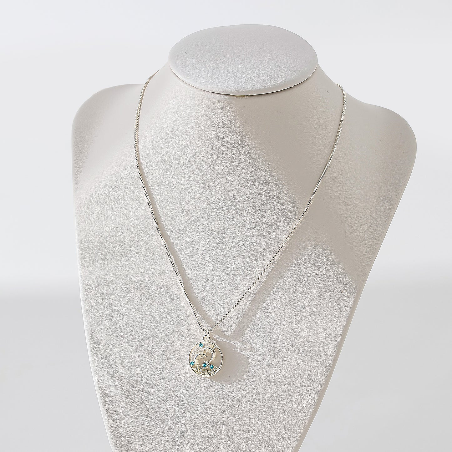 Dolphins on round pendant with blue crystals Necklace