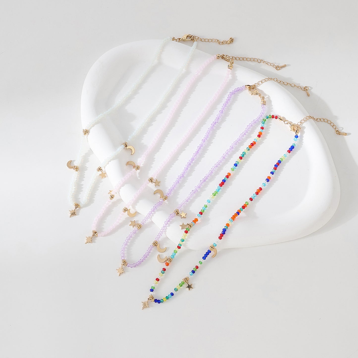 Enchanting 4 - Strand Assorted Bead Necklace with Dainty Moon and Star Charms