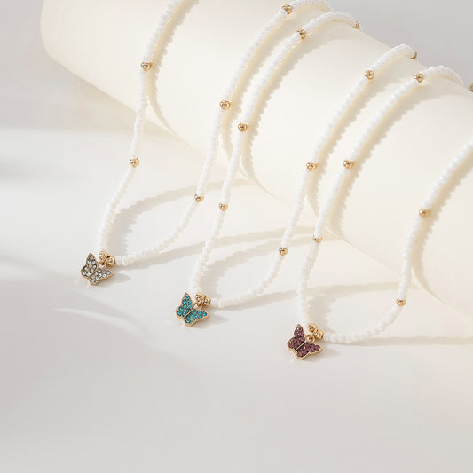 Assorted crystal Butterfly golden charm with small pearls and golden bead Necklace
